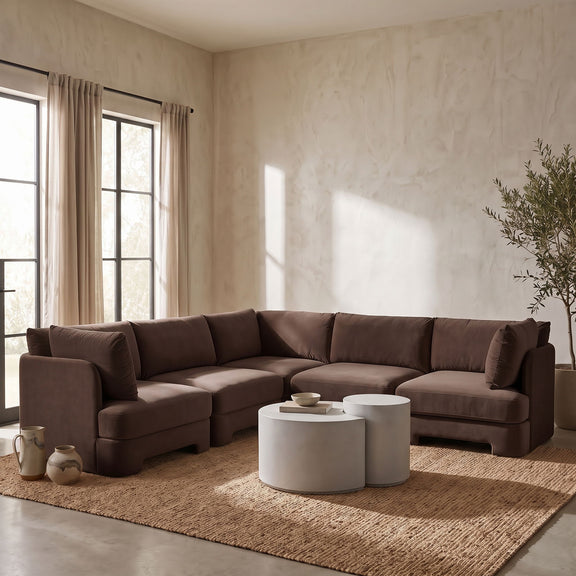 Dark brown velvet corner sectional sofa in living room setting with chaise module.