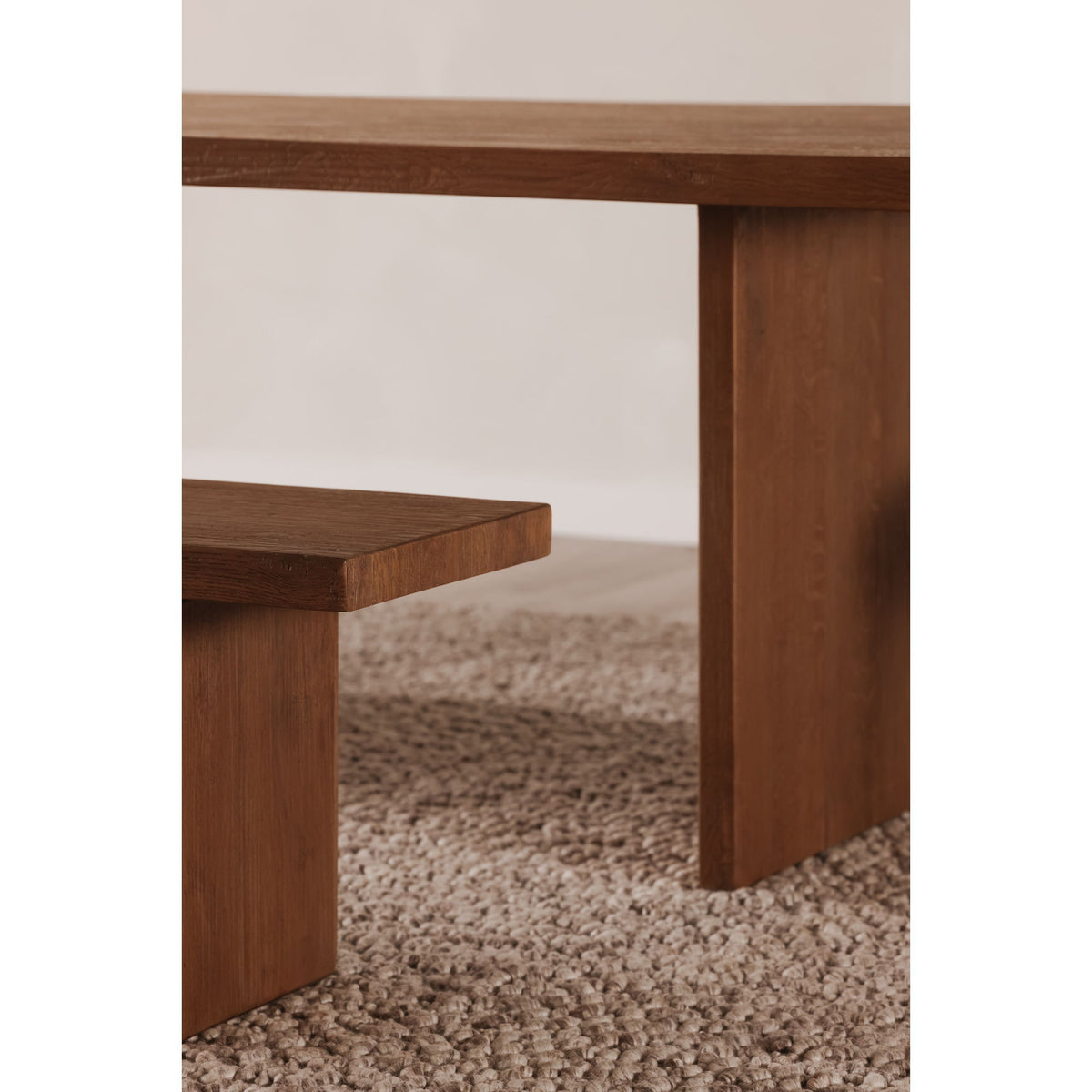 Amber oak dining table corner detail with smooth apron and open under-shelf