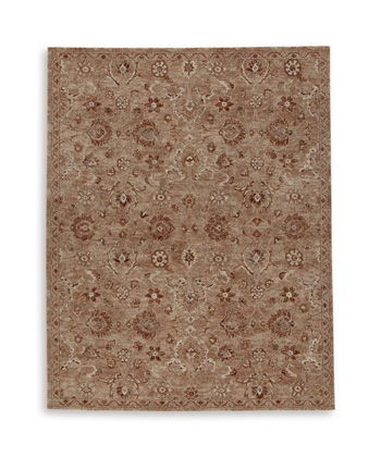Light brown area rug with repeating floral motifs and geometric medallions