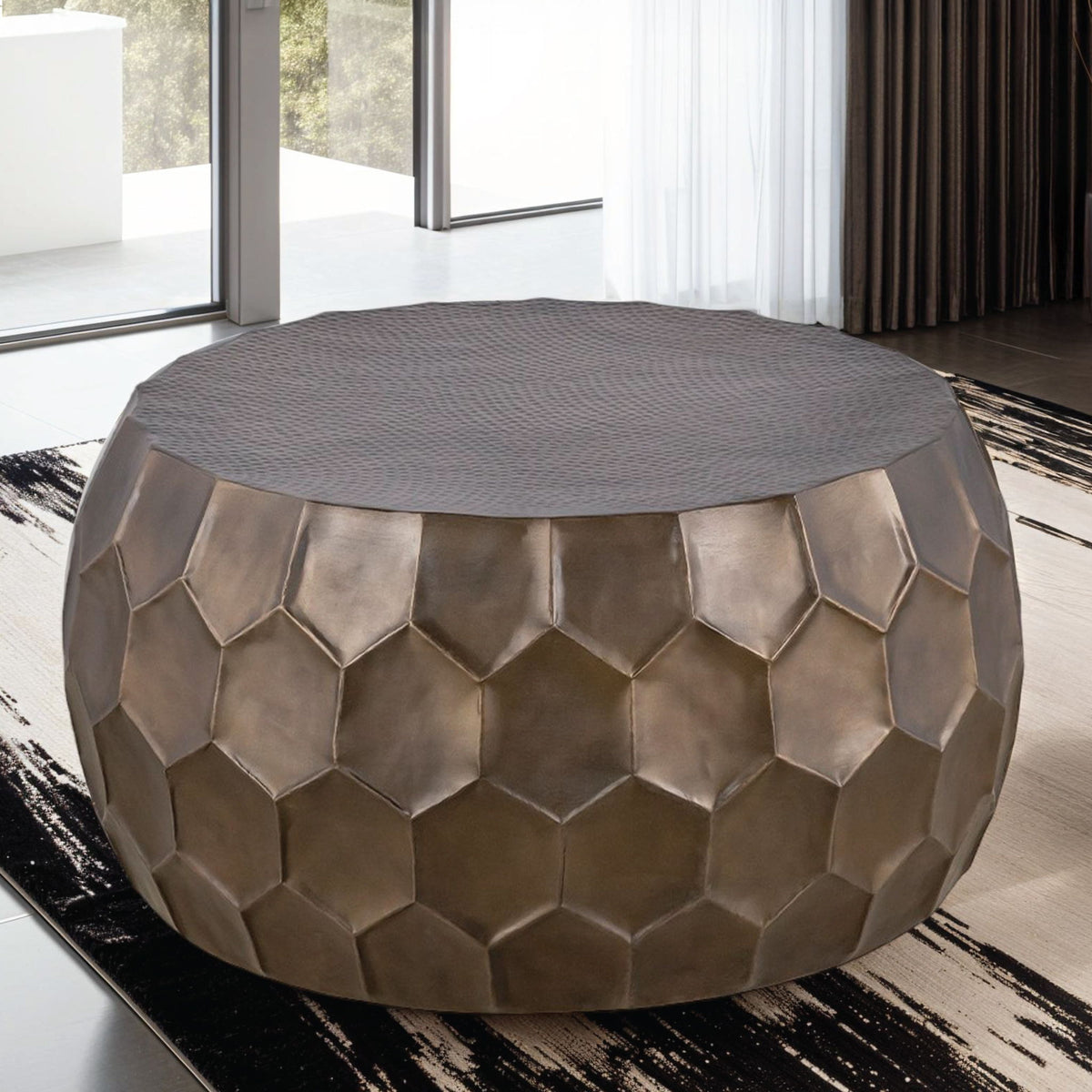 Round coffee table, 3/4 view, bronze hex metal sides and gray fabric top