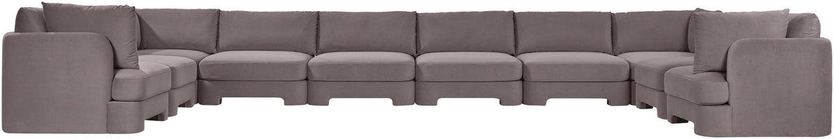Light gray velvet sectional sofa with modular seating and padded back cushions