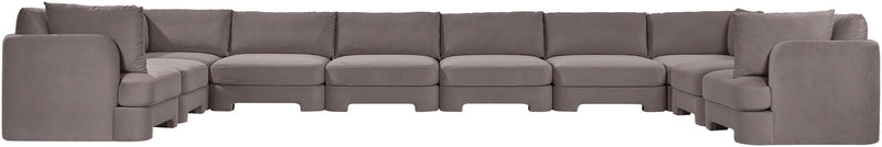 Light gray velvet sectional sofa with modular seating and padded back cushions