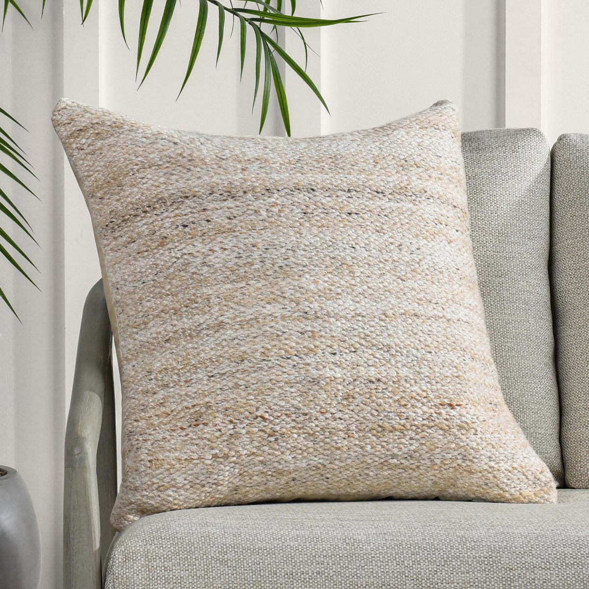 Speckled woven lumbar pillow, warm beige with knife-edge seam and piped edges
