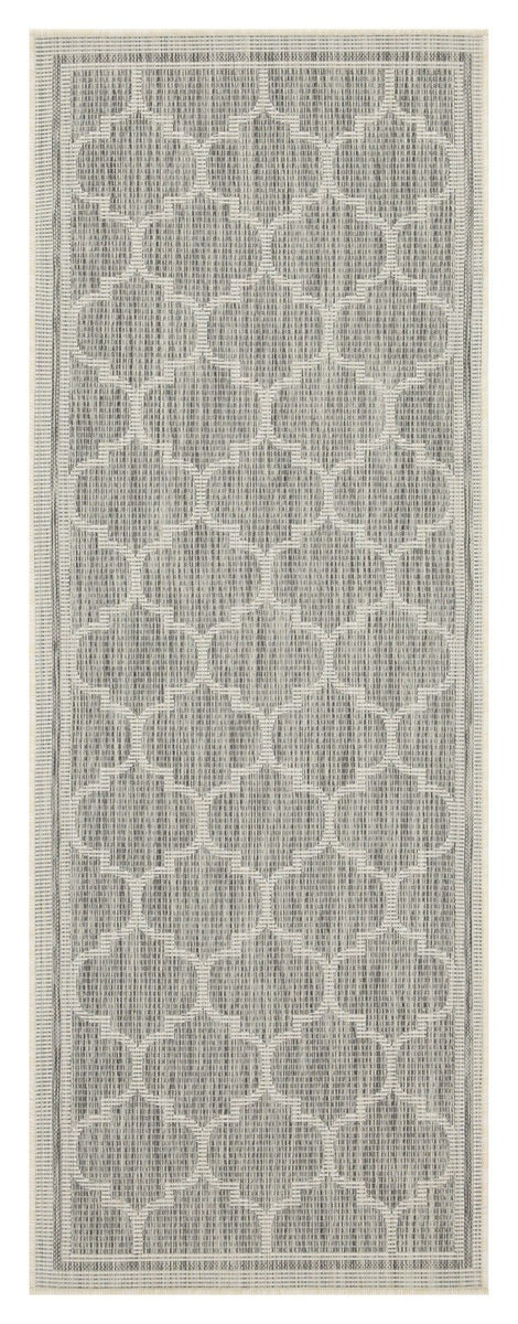 Light gray polypropylene area rug close-up showing quatrefoil pattern and border