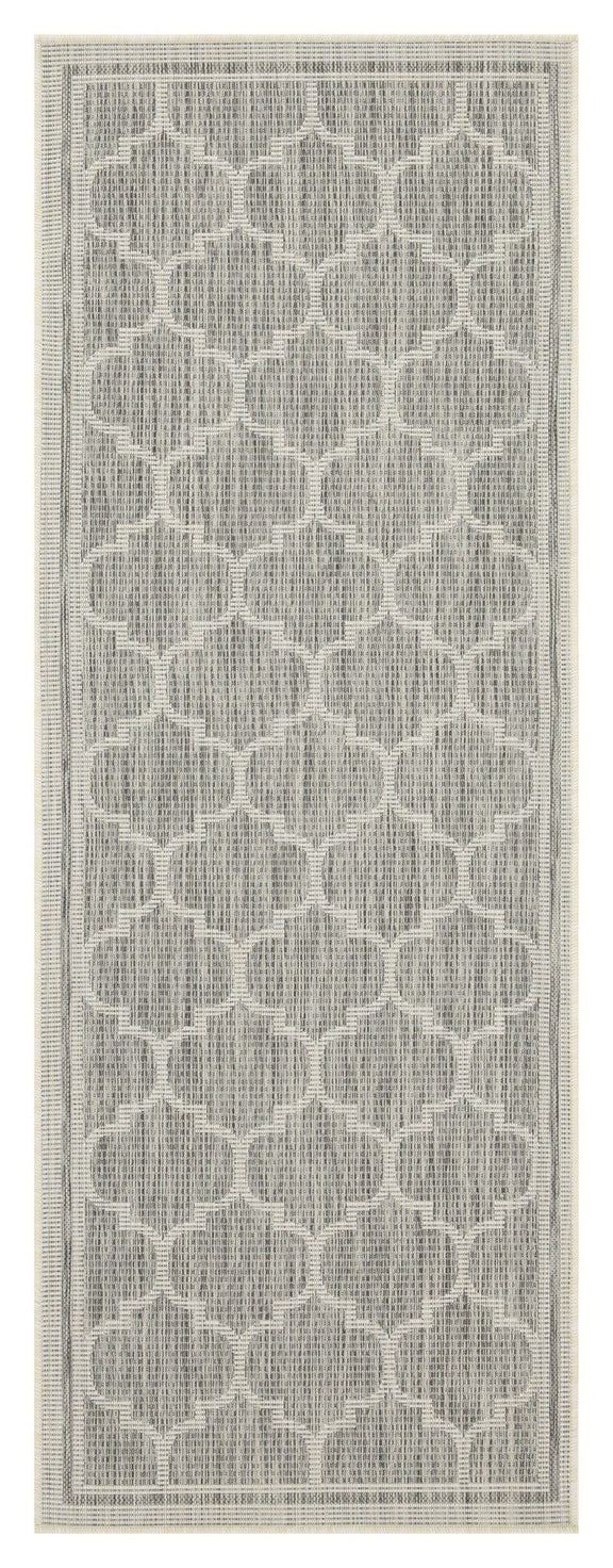 Light gray polypropylene area rug close-up showing quatrefoil pattern and border