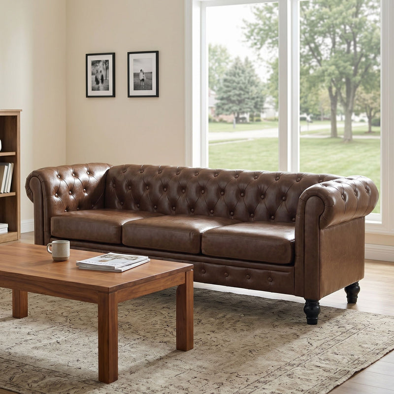 Dark brown tufted sofa with rolled arms, three cushions and button details, viewed at an angle.
