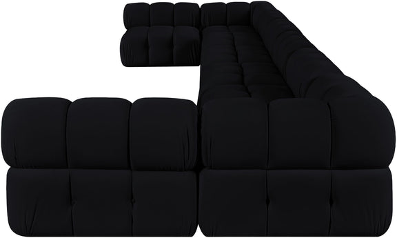 Black modular sectional sofa with tufted cushion blocks and rounded chaise corner