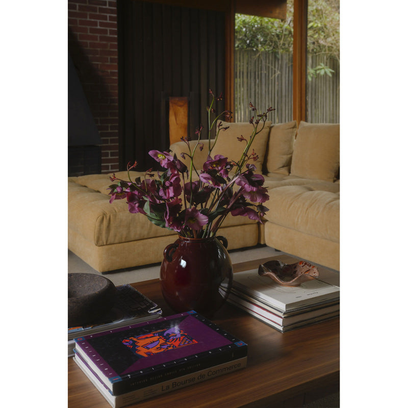 Walnut brown coffee table with rectangular top, shown from the front with books.