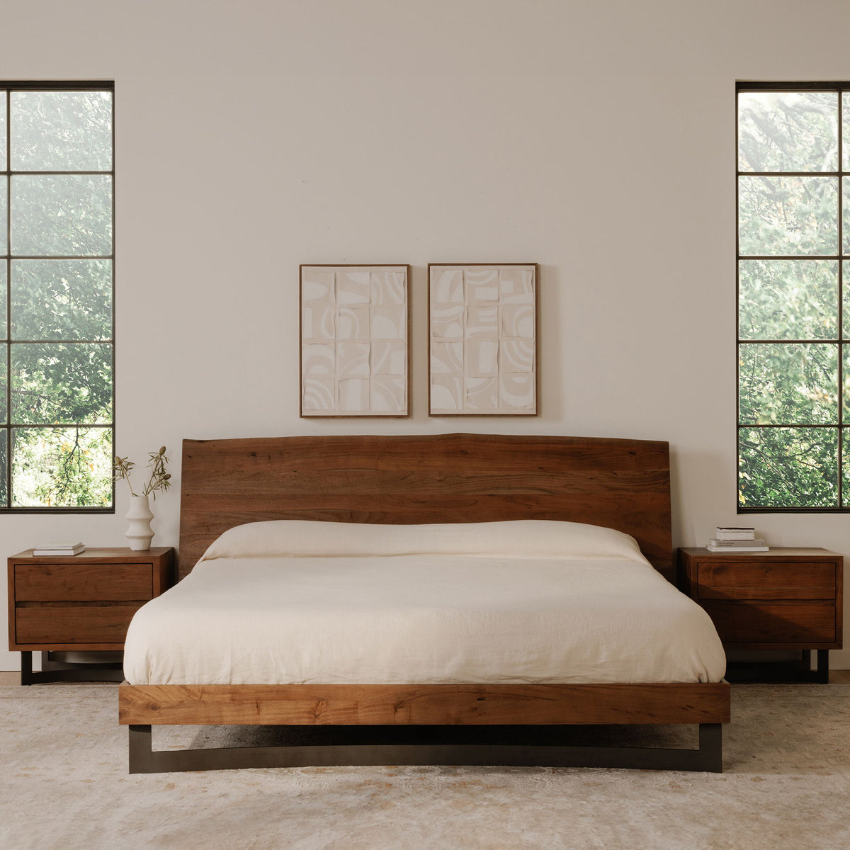 Smoked wood nightstand with two drawers beside bed and dark angled base