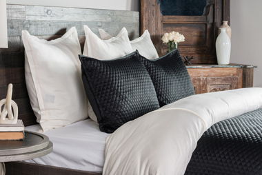 Diamond-quilt bed pillows and throw in dark gray/black with textured diamond stitch pattern