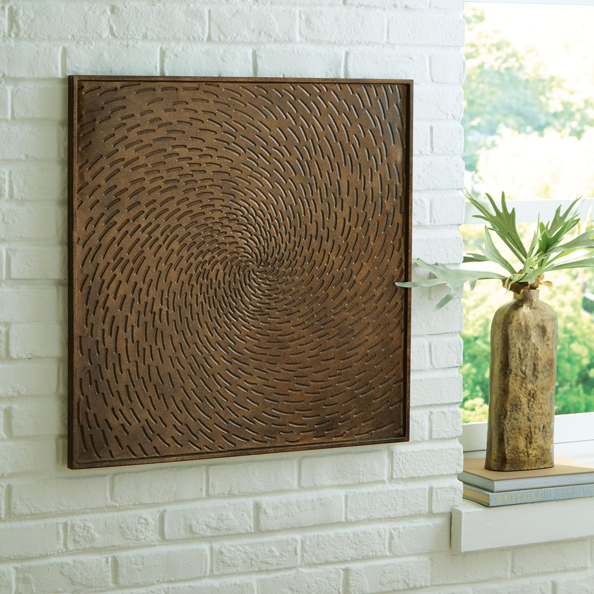 Antique brown framed wall art with concentric swirl relief pattern