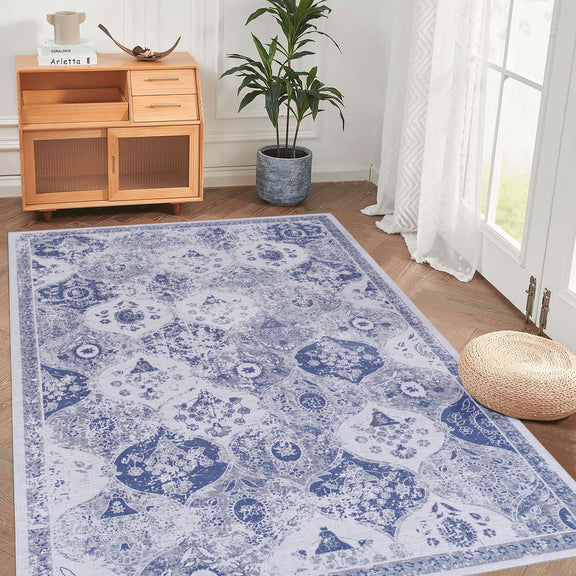Blue and white ornate area rug with distressed medallion pattern and detailed border