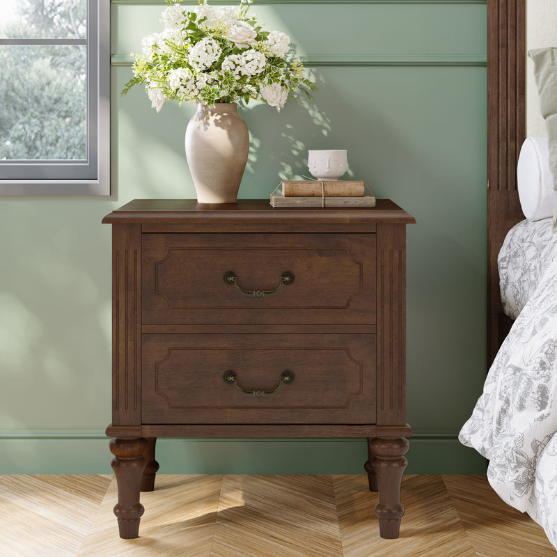 Walnut bedside table with two drawers and turned legs, brass-toned handles