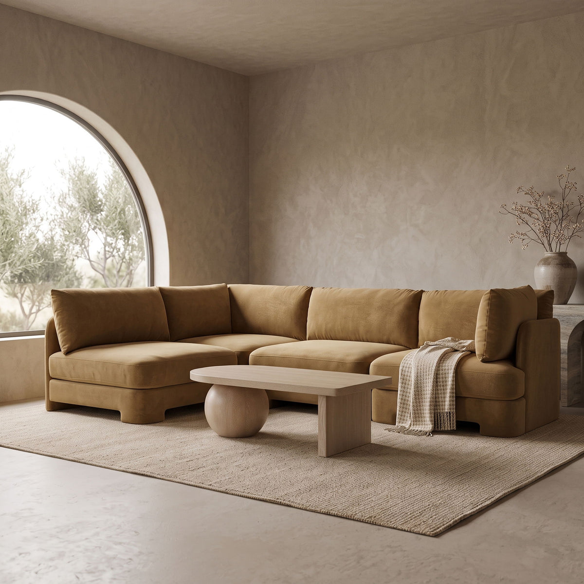 Tan velvet armless sectional sofa with rounded arms and tufted back cushions