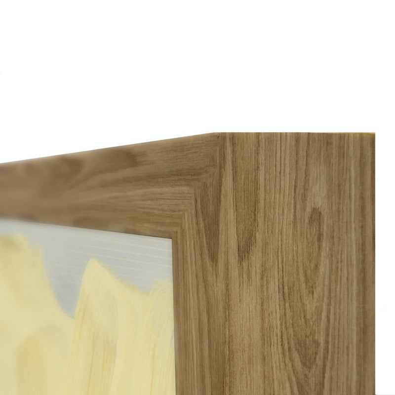 Abstract painting corner in light wood frame, showing white and pale yellow brushstrokes