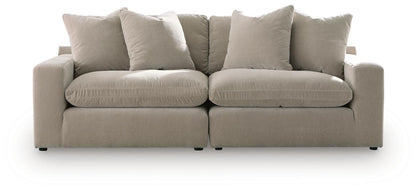 Beige 2-piece sectional sofa with four back cushions and wide, squared arms