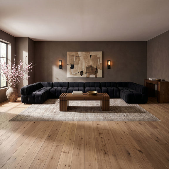 Black modular sectional sofa with tufted cushions and curved chaise corner design