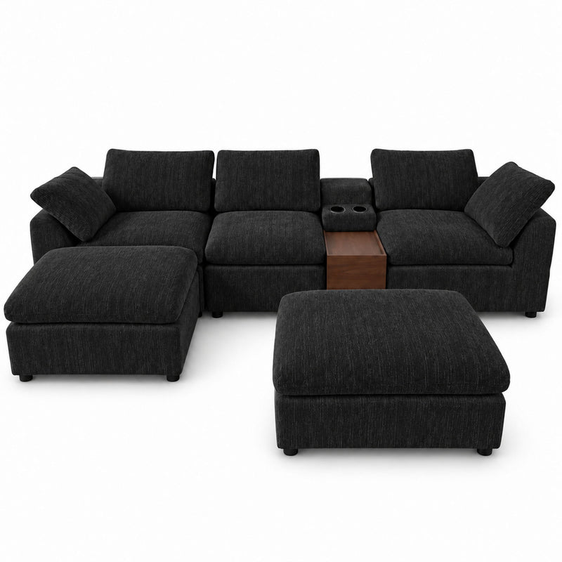Black sectional sofa with storage console and chaise ottoman, multiple square pillows