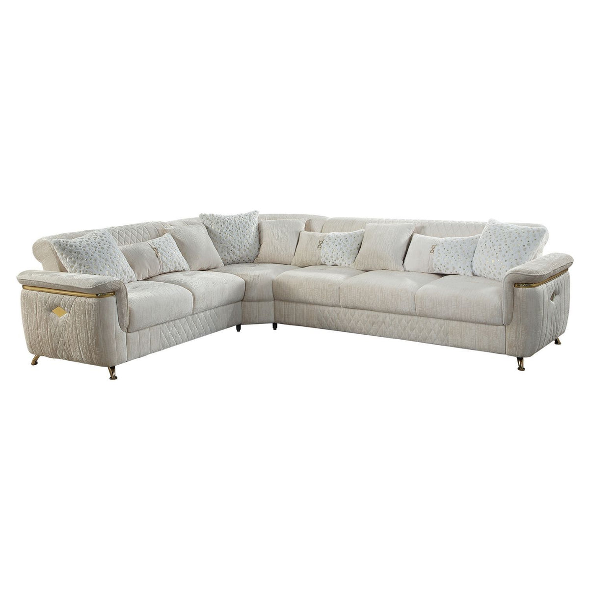 Reversible sectional sofa in light beige with patterned accent pillows and gold-trimmed arms