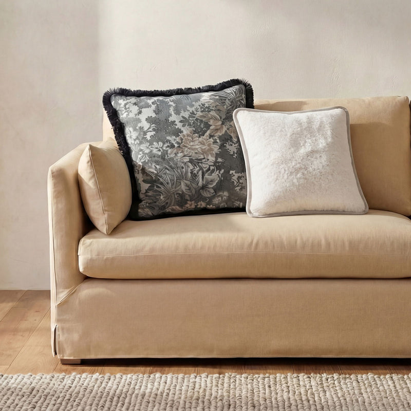 Cream/white faux fur 20-inch square cushion on a sofa, plush textured front