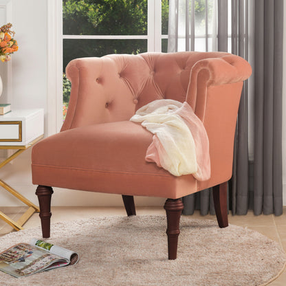 Tufted accent chair in dusty orange with rounded arms and button-tufted backrest.