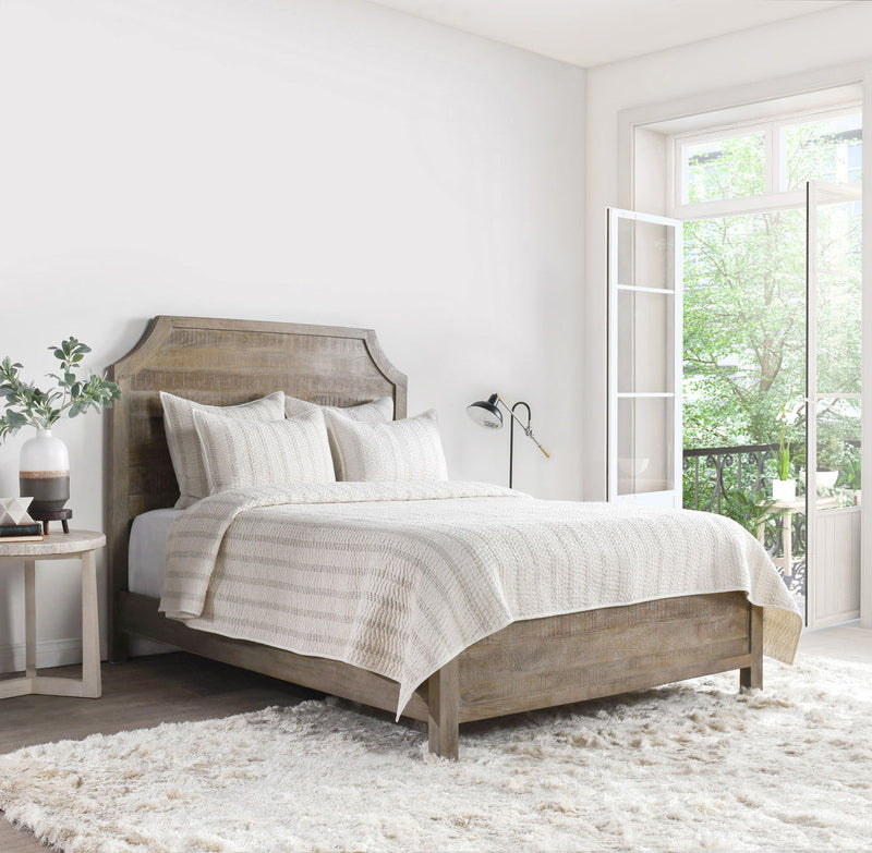 Eggshell cotton-linen quilt draped on bed with subtle textured stripes