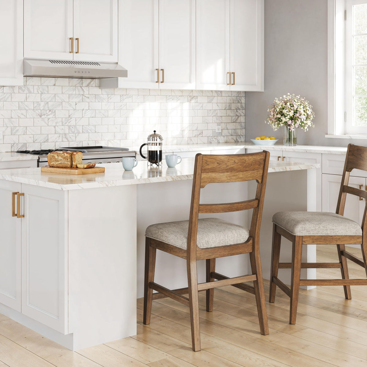 Two light brown barstools with oatmeal upholstered seats and ladder backs