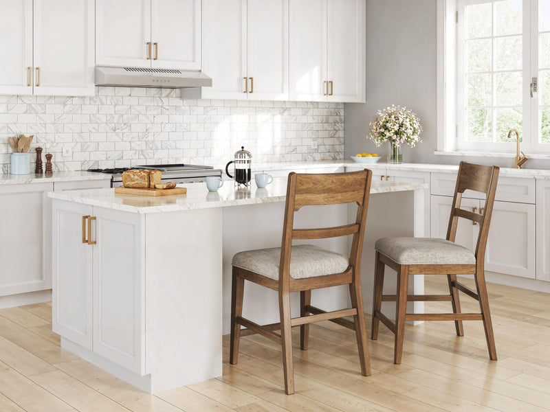 Two light brown barstools with oatmeal upholstered seats and ladder backs