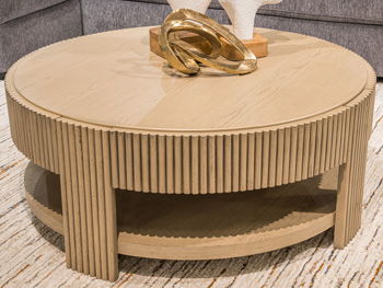 Light brown ribbed round end table with open lower shelf