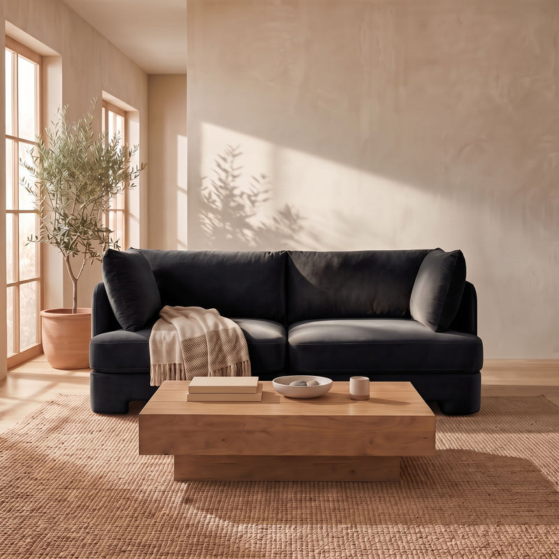 Black velvet upholstered loveseat with rounded arms and two back cushions