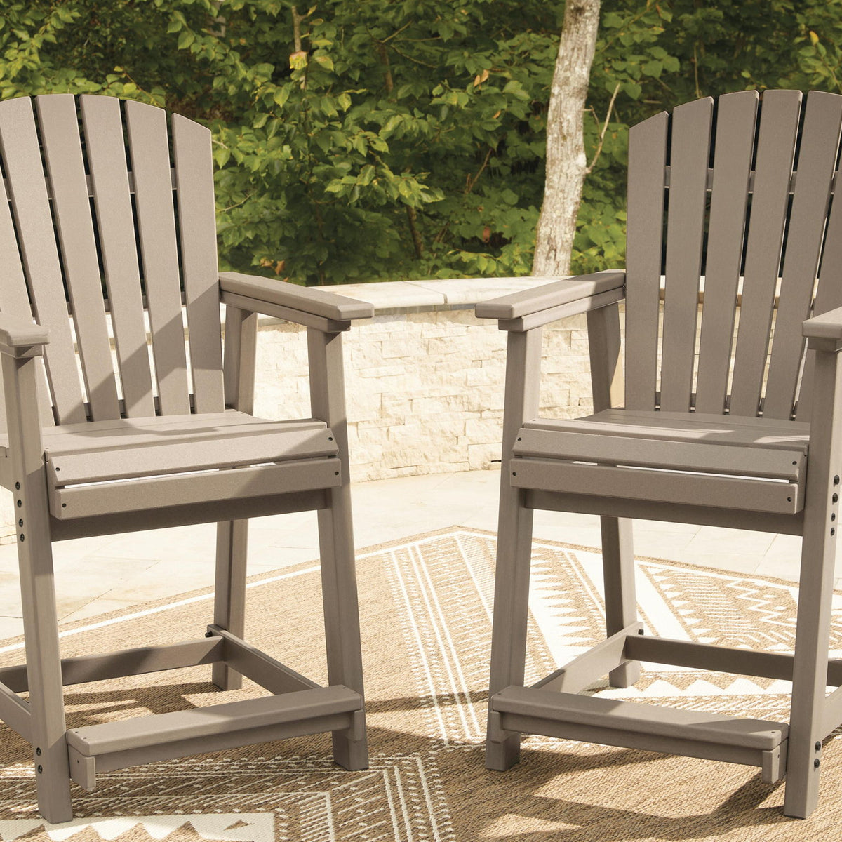 Medium brown wooden outdoor barstools with slatted backrests and armrests