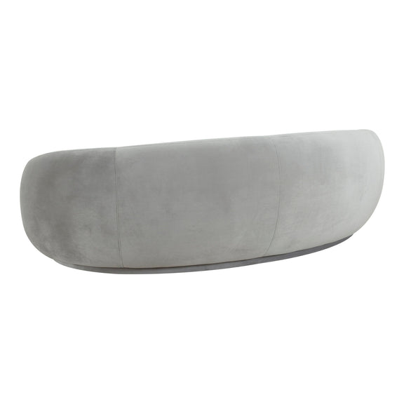 Velvet sofa in light gray with rounded back and curved, armless profile