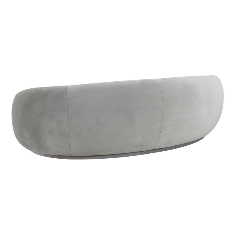 Velvet sofa in light gray with rounded back and curved, armless profile