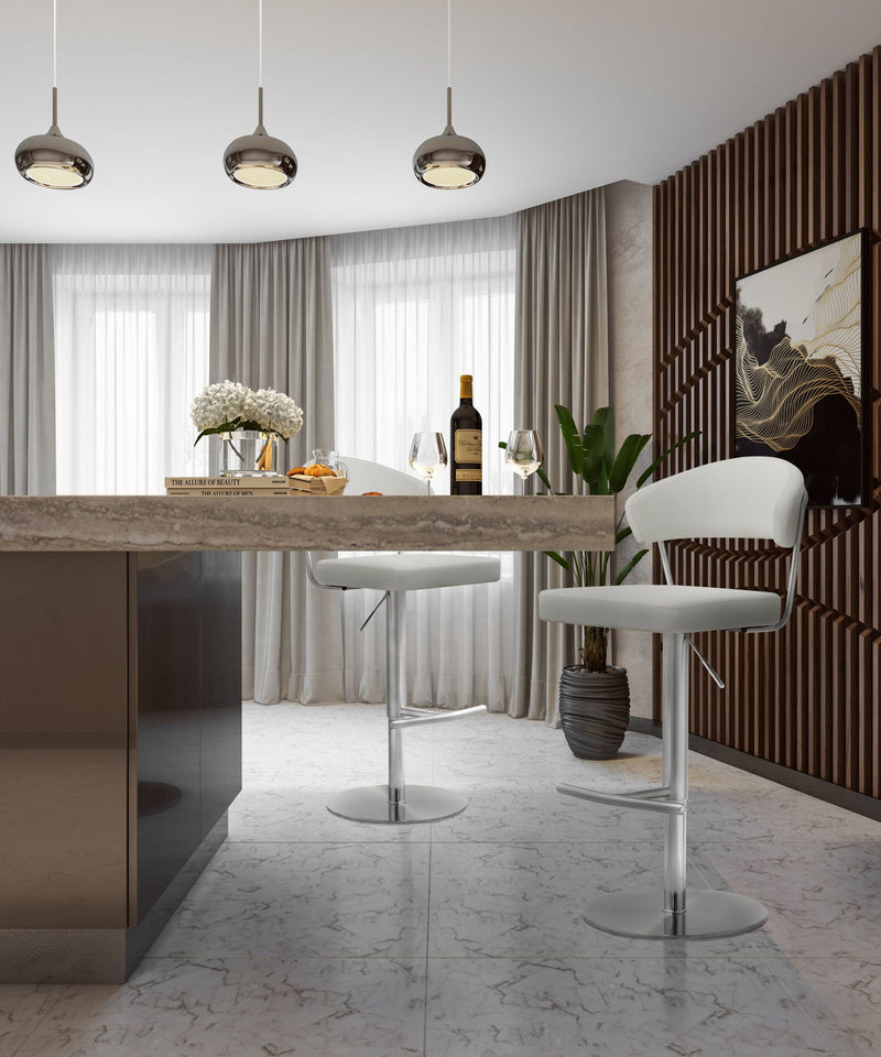 White cushioned barstool with curved back, chrome pedestal base, and footrest in a room.