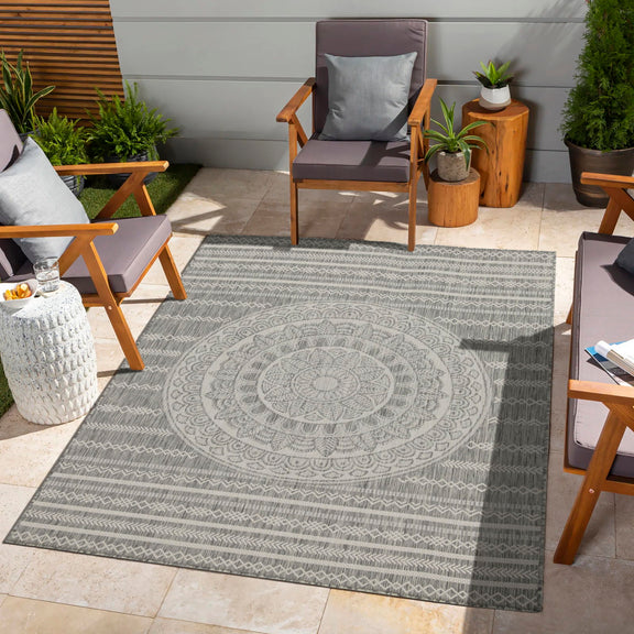 Indoor outdoor polypropylene area rug, dark gray with large circular medallion design