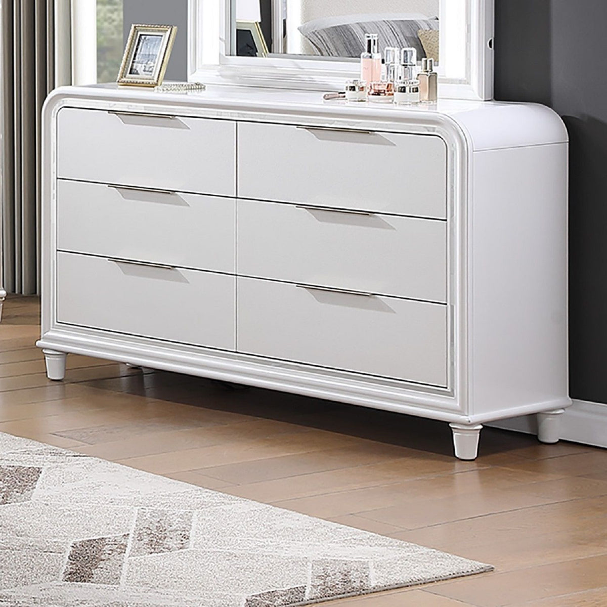 White 6-drawer dresser with chrome edging, low legs, and long silver bar handles
