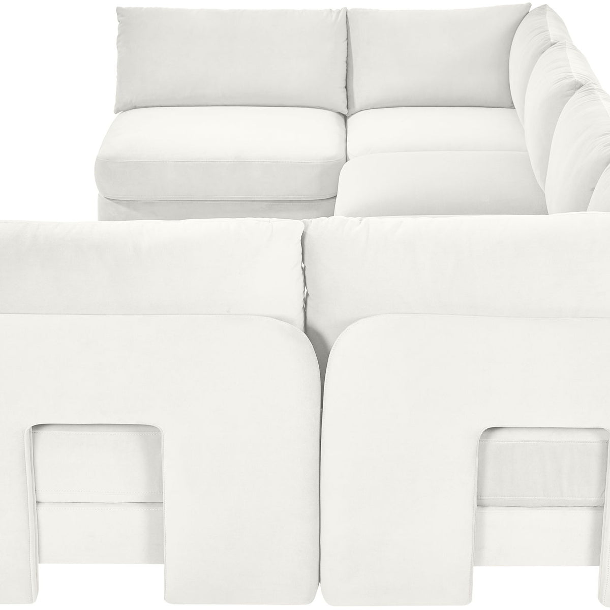 White velvet armless sectional sofa close-up with padded seat and back cushions