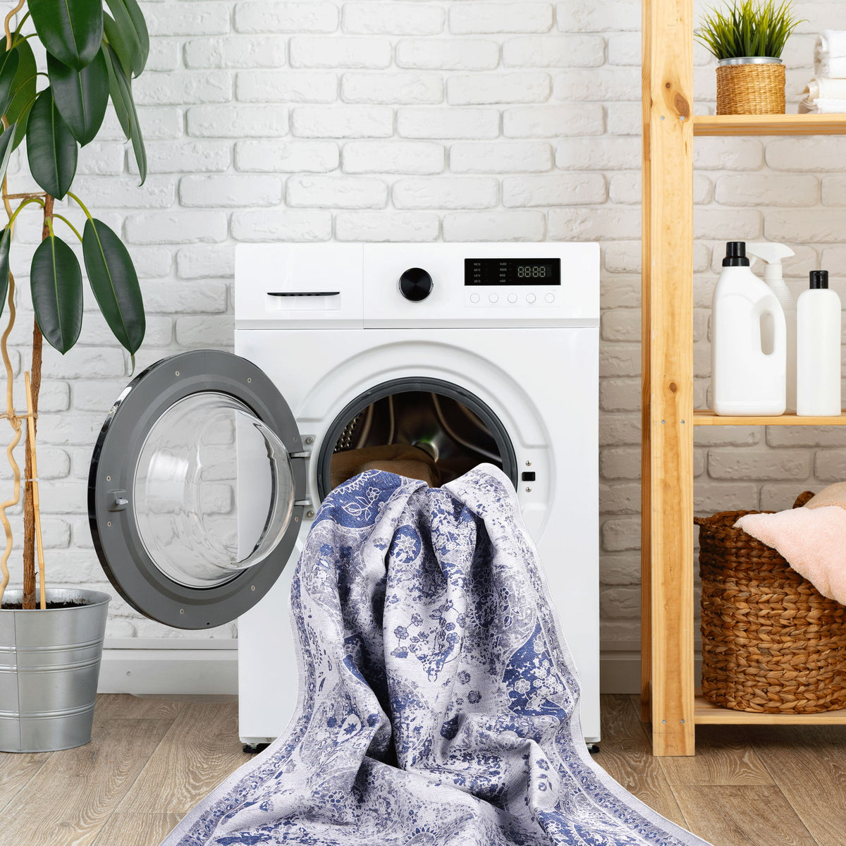 Blue and white washable area rug, folded and shown coming out of a washer