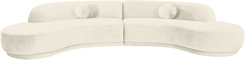 Light cream velvet sectional sofa with rounded arms and deep seat cushions