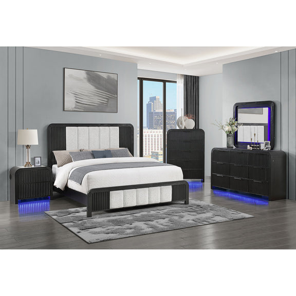 Black upholstered bed with fluted headboard, gray panels, and white comforter.