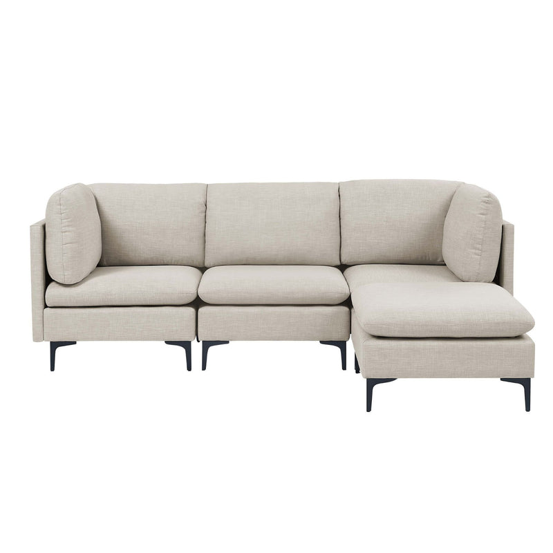 Beige L-shaped sectional sofa with matching ottoman bench and tall black legs
