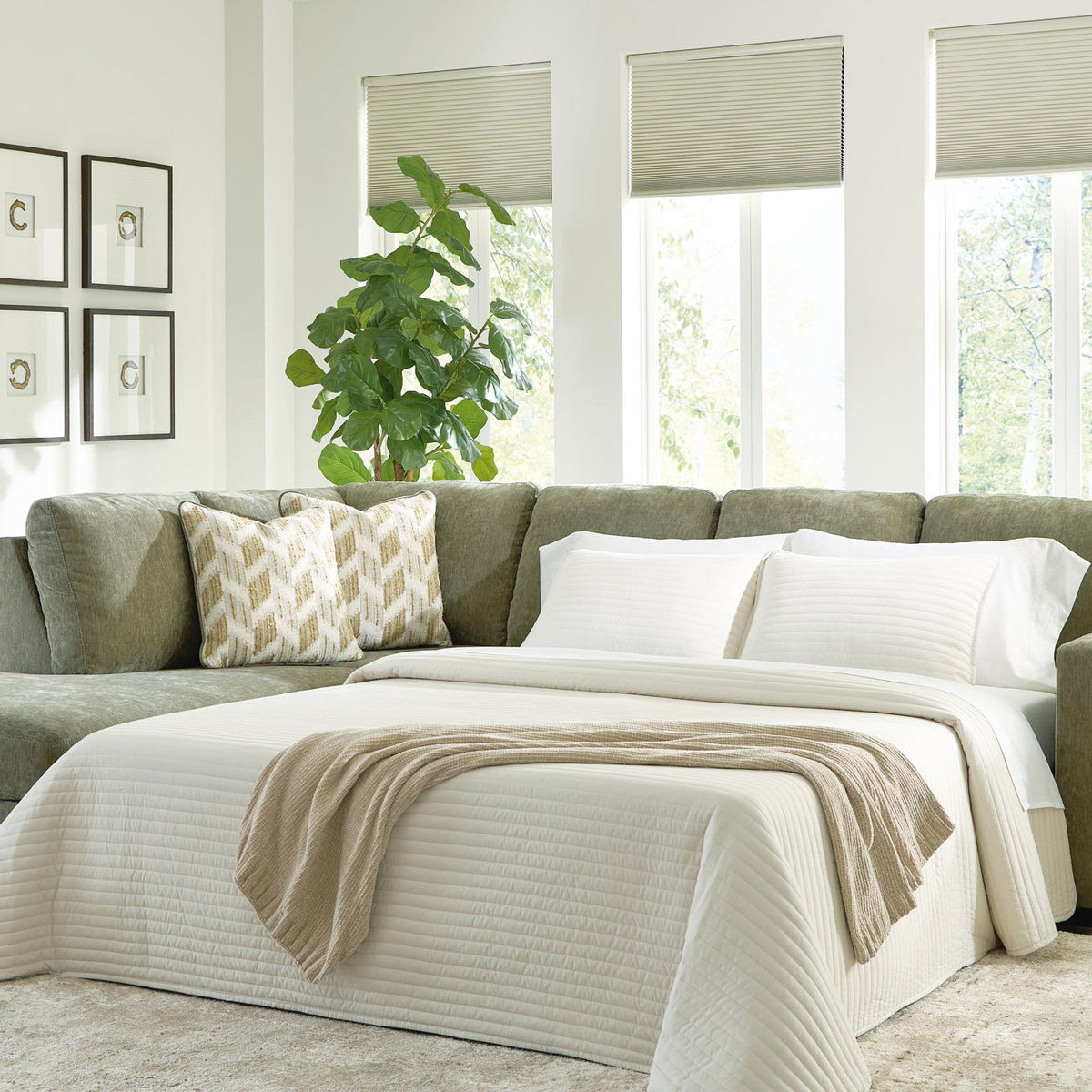 Green sleeper sectional sofa with corner chaise and white throw pillows