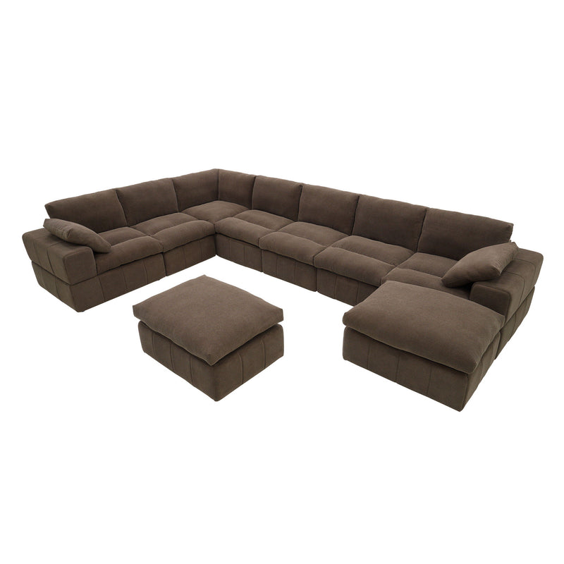 Dark brown L-shaped sectional with two ottomans and loose toss pillows