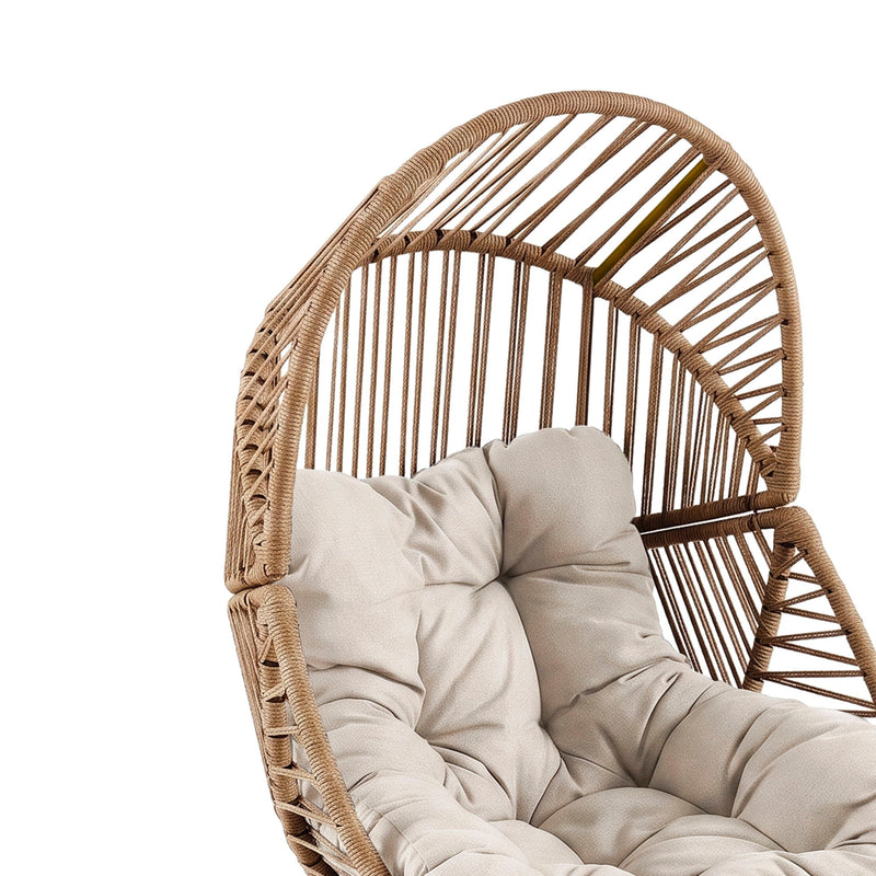 Light brown rattan lounge chair with beige padded cushion and curved woven back