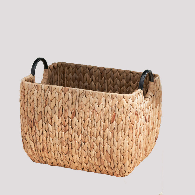 Light brown woven storage basket with a rectangular shape and black loop handles.