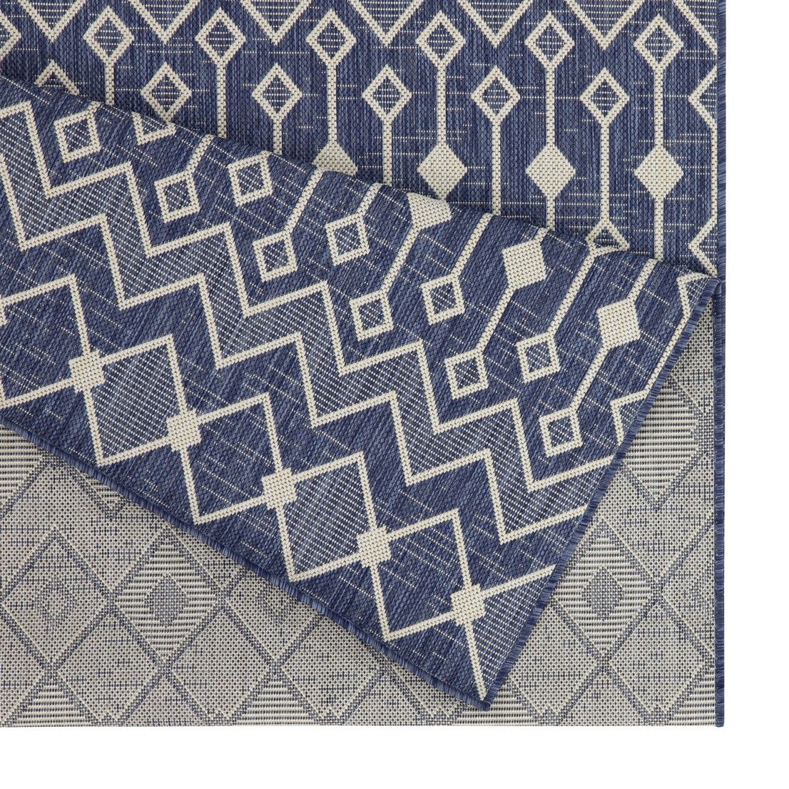 Indoor/outdoor polypropylene area rug, blue with white chevrons and diamond motif border.