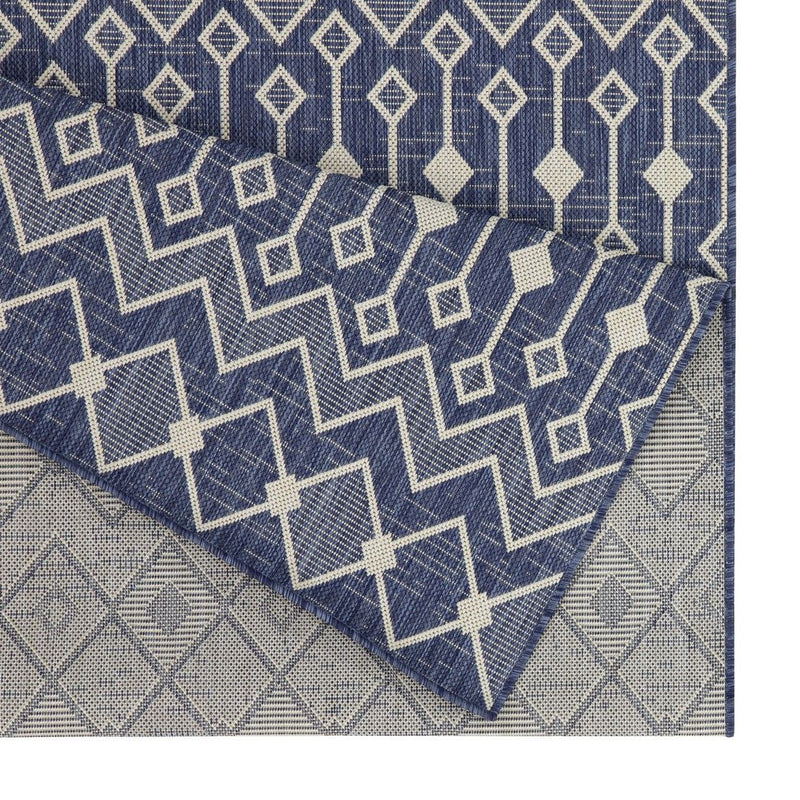 Indoor/outdoor polypropylene area rug, blue with white chevrons and diamond motif border.