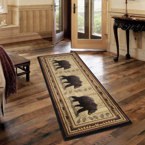 Rectangular lodge area rug in cream and dark tones with black bear motif and patterned edge