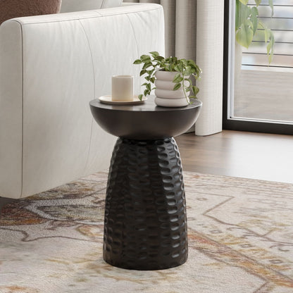 Handcrafted accent table with dark sculpted base and round top