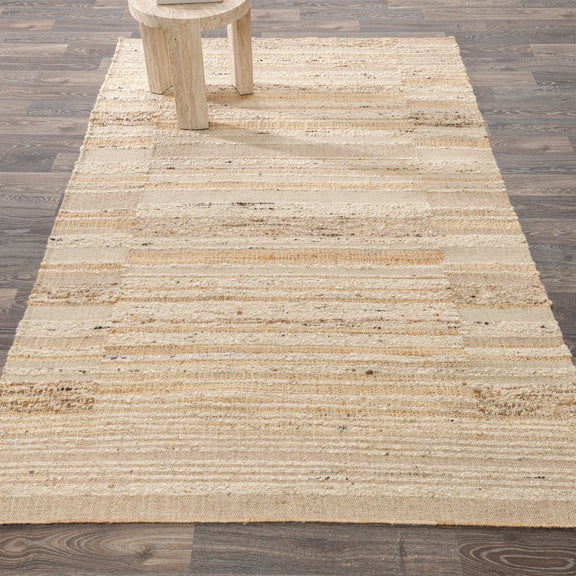 Natural area rug with low-pile woven stripes and speckled, textured surface